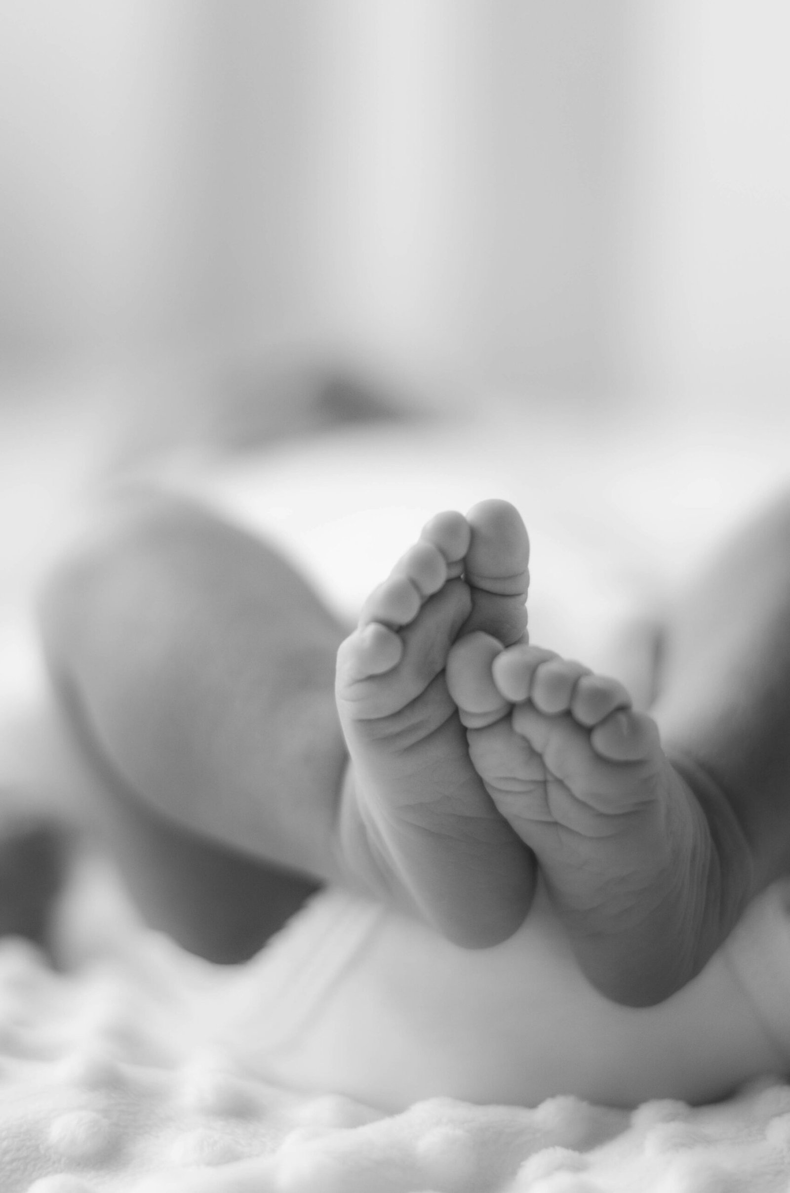 Close-up of a baby's feet showing the stepping reflex on a flat surface