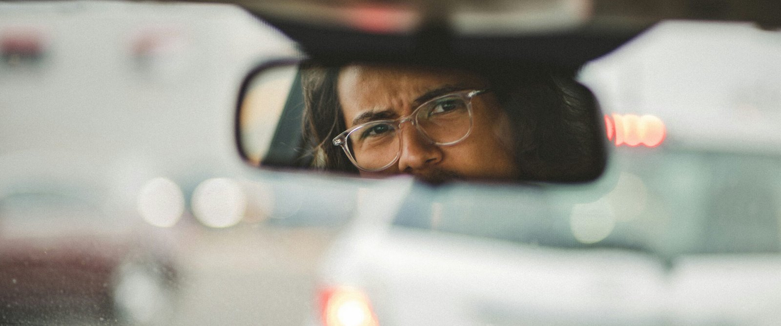 Angry man wearing black-framed glasses, reflecting the challenge of extreme irritability and the need for brain reorganization to improve emotional regulation and midbrain function.