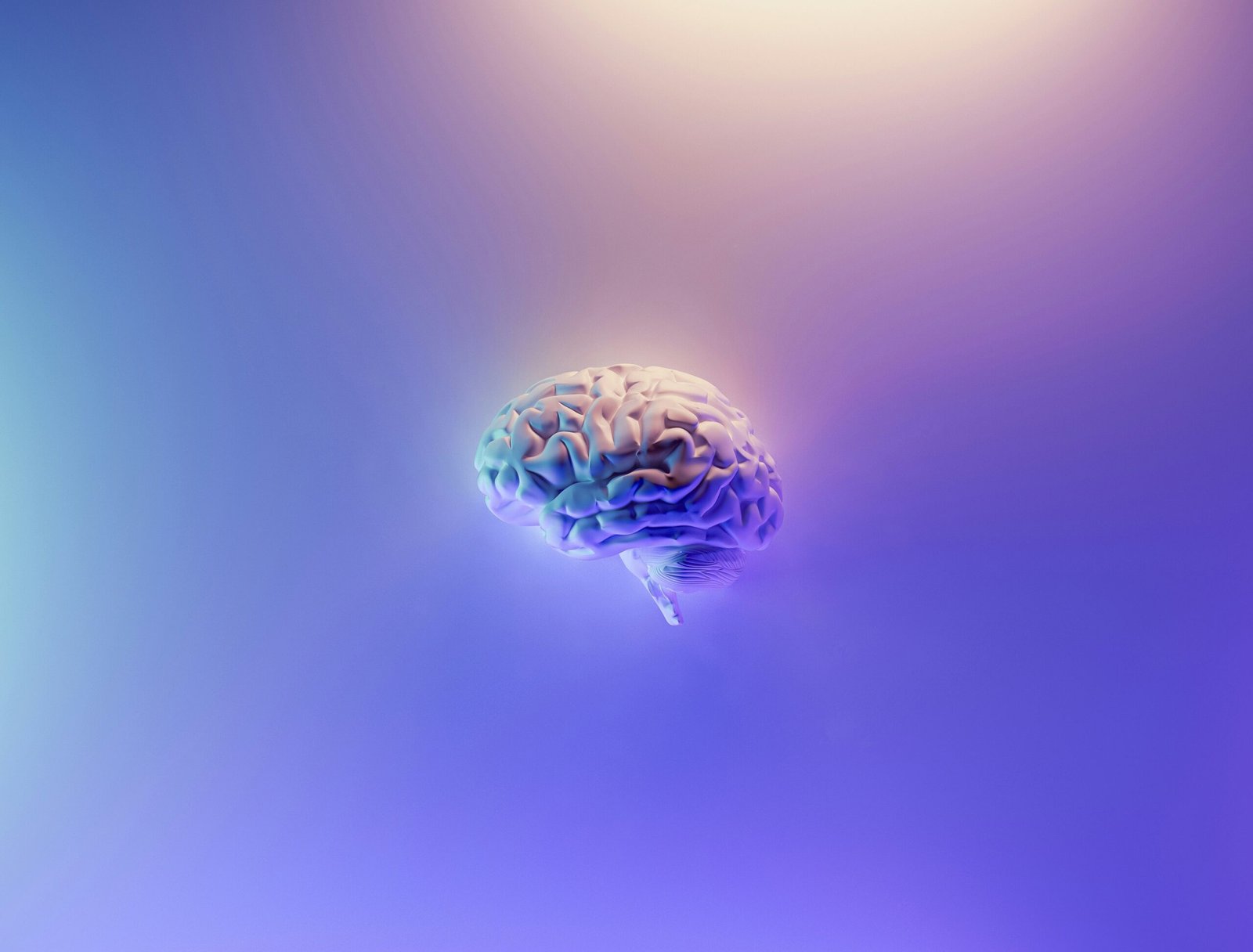 Close-up of a vibrant blue and green peacock feather symbolizing brain reorganization, neuroplasticity, and mental transformation.