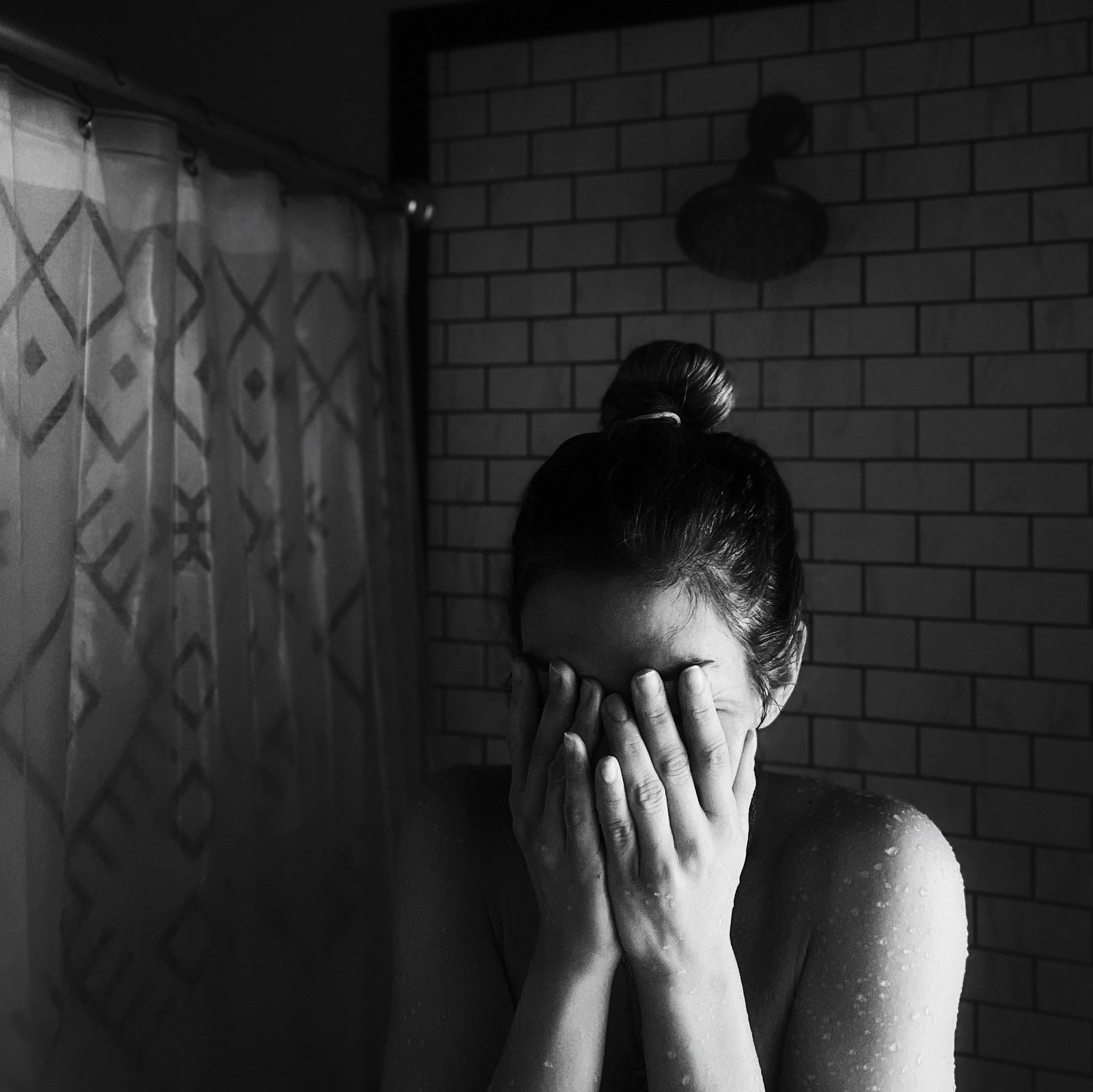 Young woman feeling shy, covering her face with both hands, symbolizing extreme shyness and social anxiety.