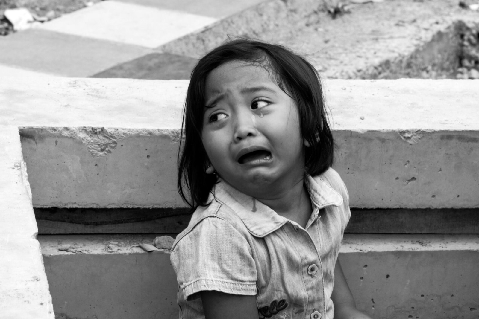 Black and white picture of a 3-year-old girl crying